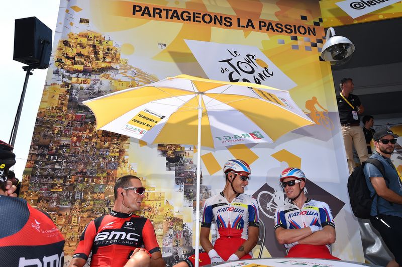 Rides relax in the start village before the stage