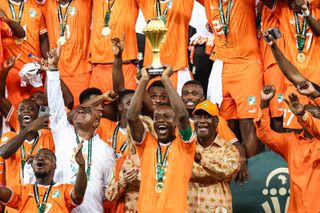 Ivory Coast players celebrate with the trophy after winning the Africa Cup of Nations in 2024.