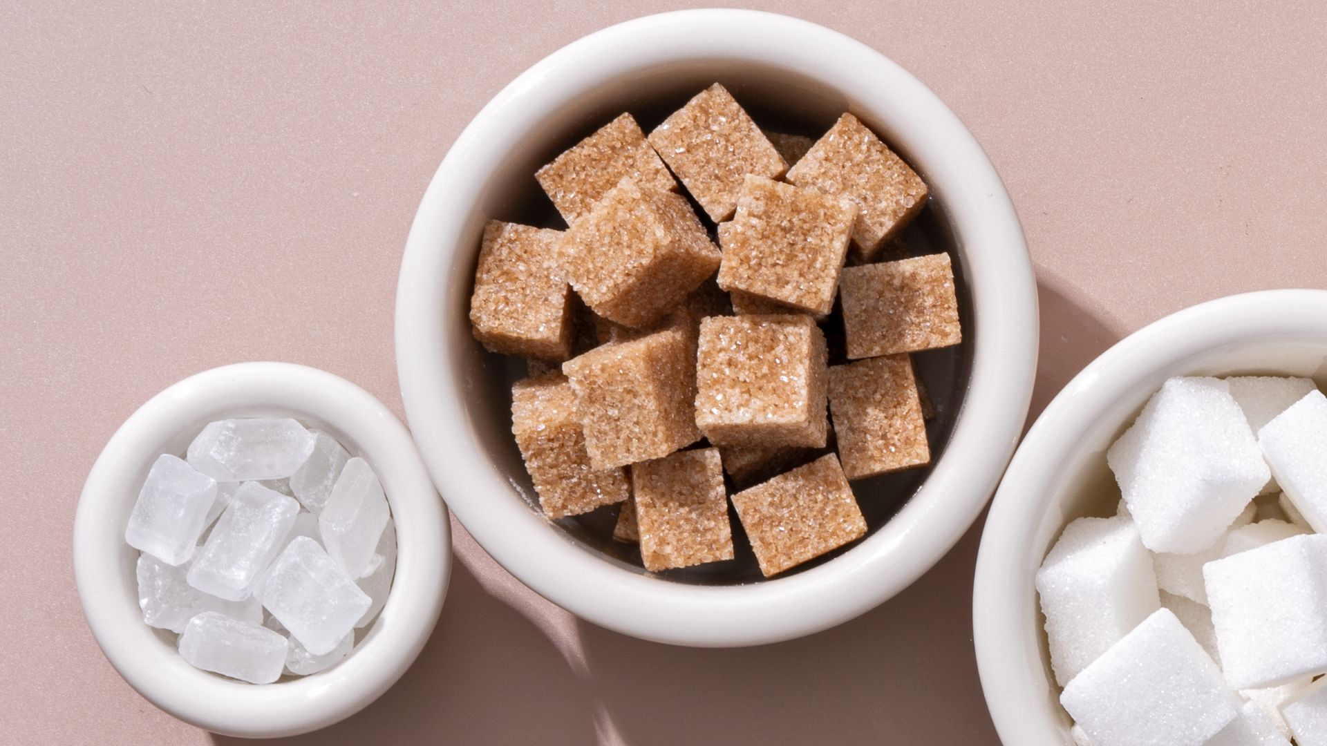 Ceramic bowl of white sugar and brown sugar
