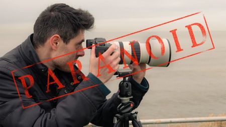 A man with a Canon EOS R3 camera and 70-200mm lens