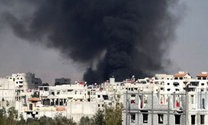 Smoke rises from the eastern Damascus suburb of Arbeen on Nov. 8, after a reported airstrike by a MIG fighter jet.