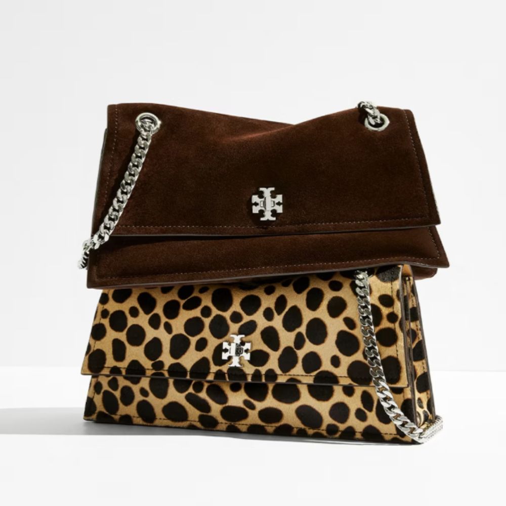 One leopard and one brown suede crossbody bag, with Tory Burch logo on, and white background.