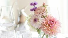 Dahlias in a bud vase on a dining table