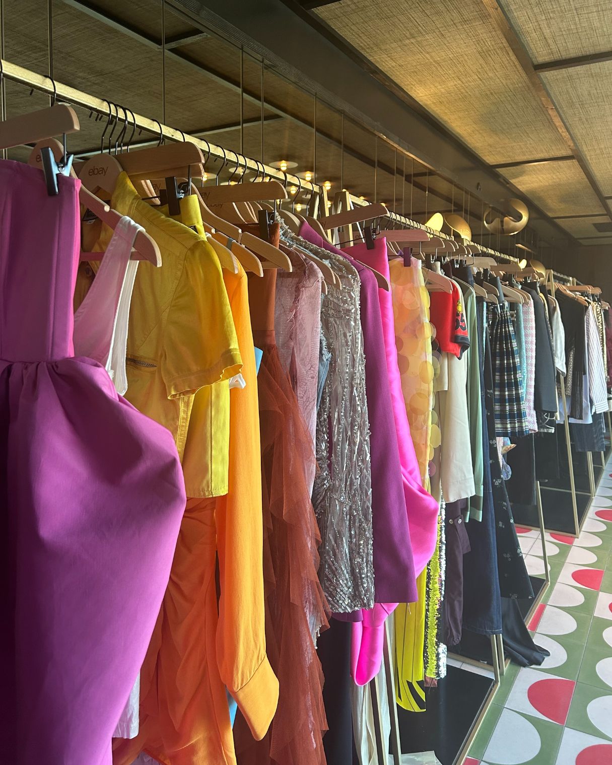 a rail of colourful clothing