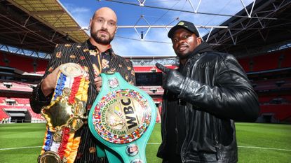 Tyson Fury (L) and Dillian Whyte (R) face-off during the press conference prior to their WBC heavyweight championship fight at Wembley Stadium on April 20, 2022 in London
