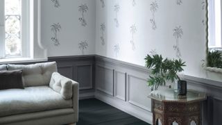 living room with grey half panelled walls and palm tree wallpaper