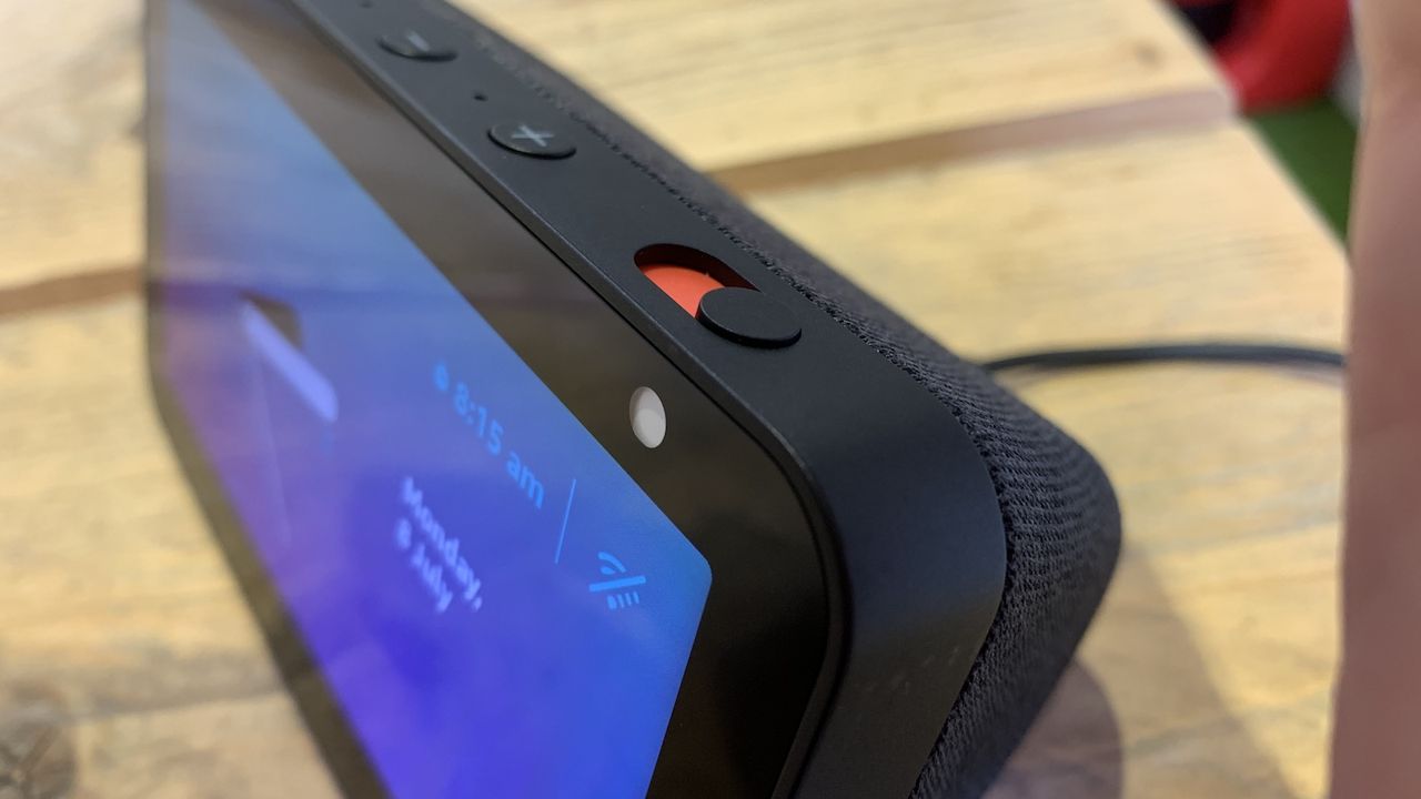 A close-up of the mute button on top of a black Amazon Echo Show 5.