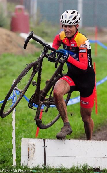 A lone racer near the back of the pack runs the barriers