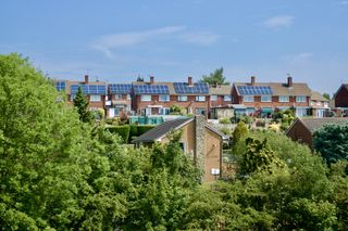 A village of houses with solar panels on the roofs