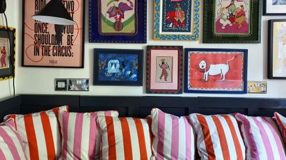 colorful embroidered artwork and striped cushions on a bench seat