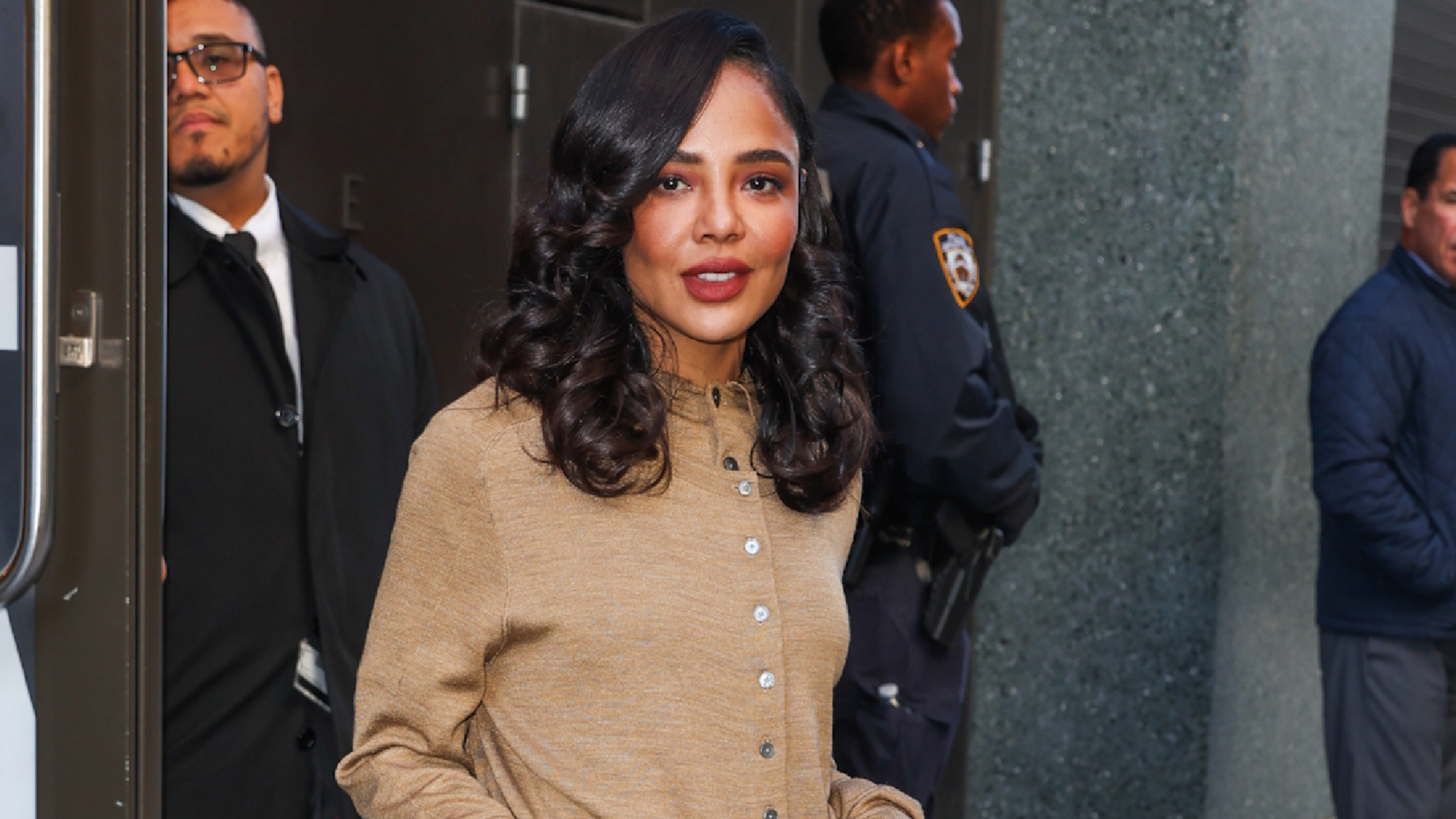 tessa thompson wears a beige cardigan.