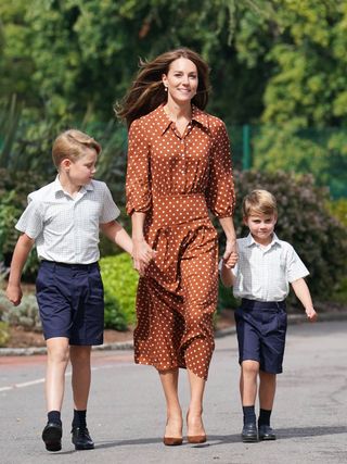 Kate Middleton walking her children to school wearing a polka dot rixo dress