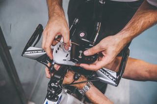 A bike fitter adjusting some handlebars