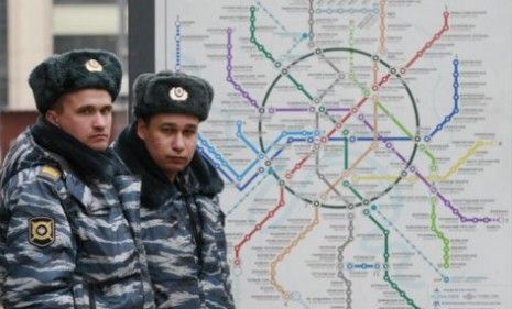 Russian policeman stand outside a subway station.