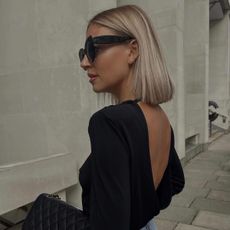 A woman with a sleek, blunt, ashy blonde bob