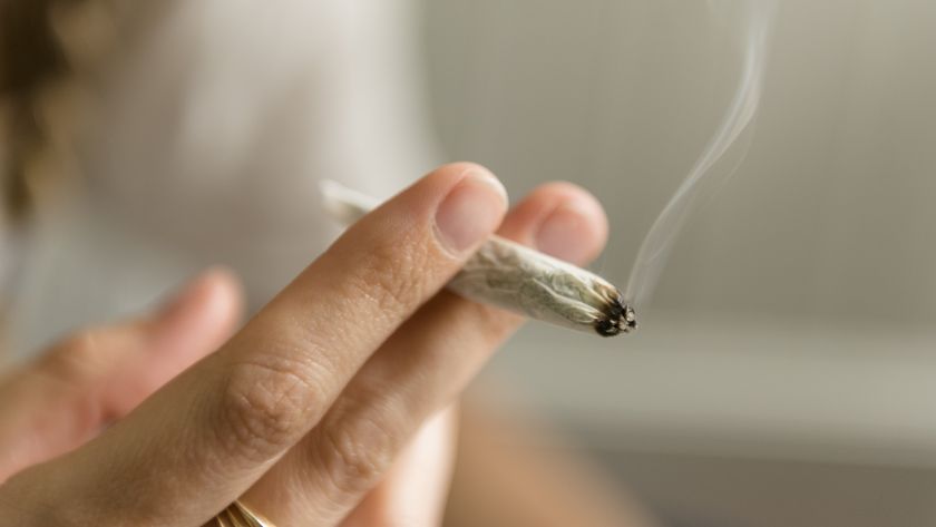a close-up of a woman&#039;s hands holding a joint