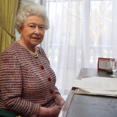 Queen Elizabeth sitting at a desk