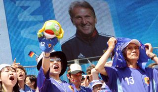 Japan fans cheer in front of an image of coach Zico ahead of a game against Croatia at the 2006 World Cup.