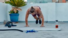 Man doing burpees on a rooftop