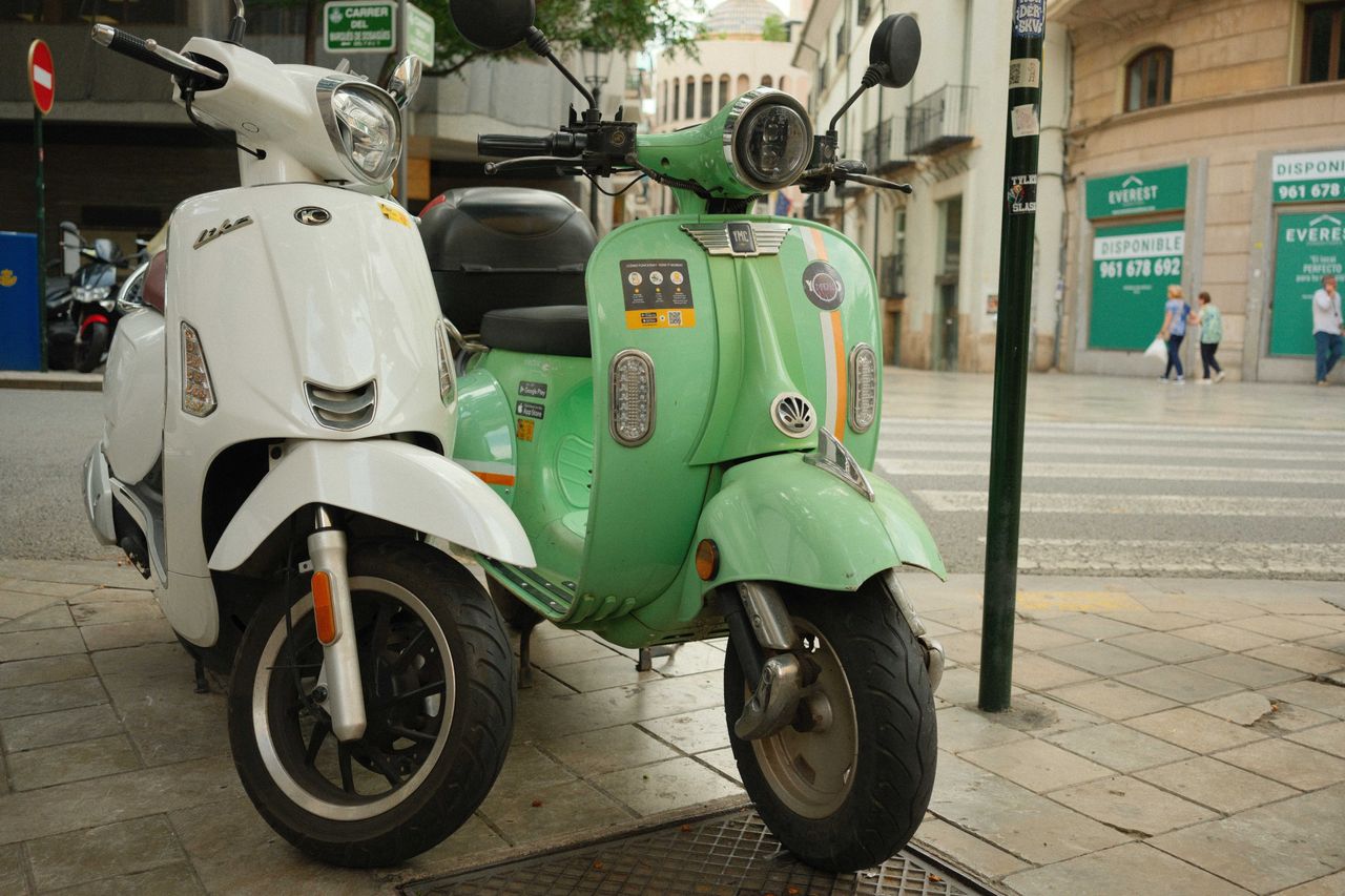 Colorful mopeds line up on a street in Valencia Spain