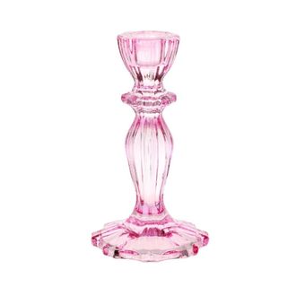 A tall pink glass candlestick holder