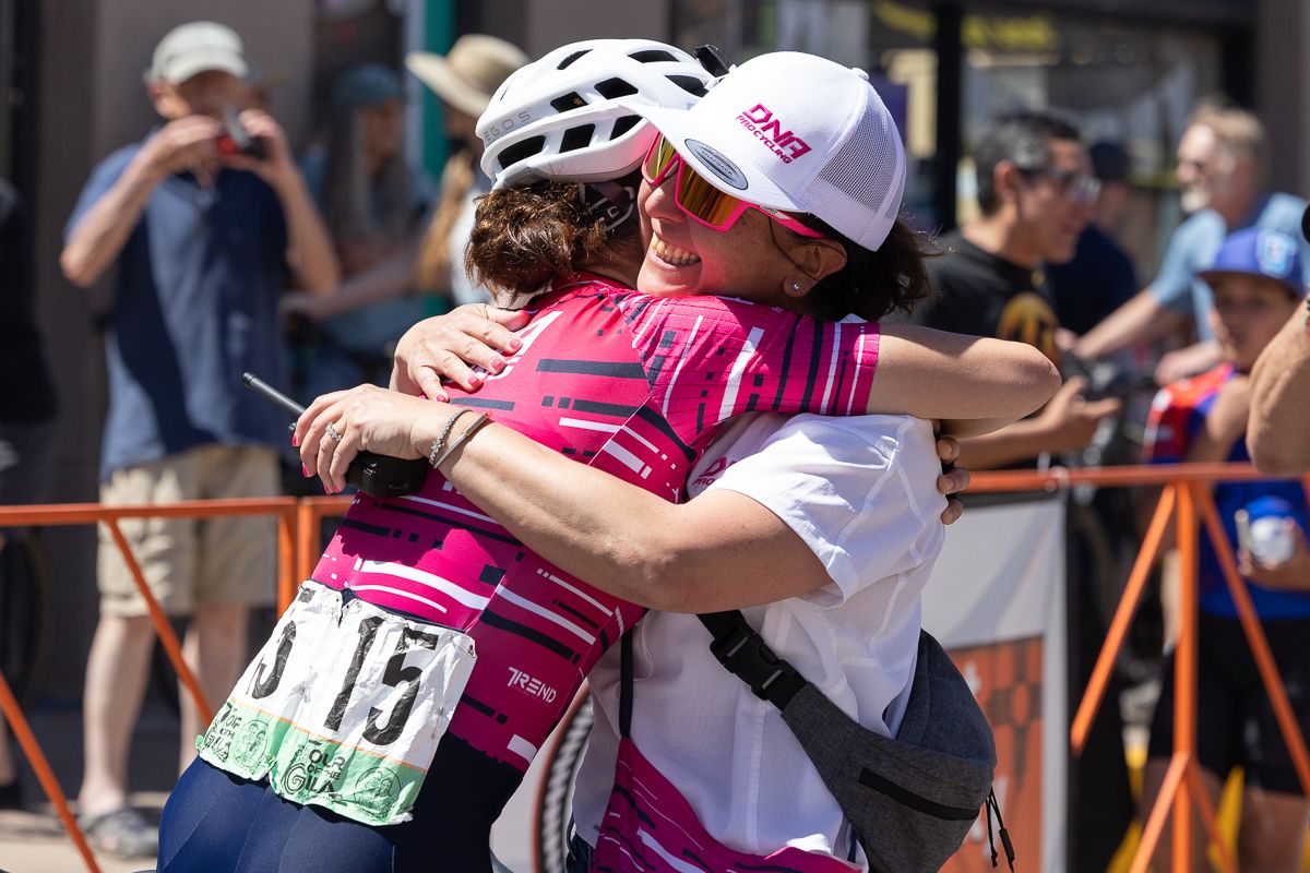 DNA Pro Cycling Team owner Cathy Fegan-Kim congratulates Holly Breck on her second place finish on stage 4