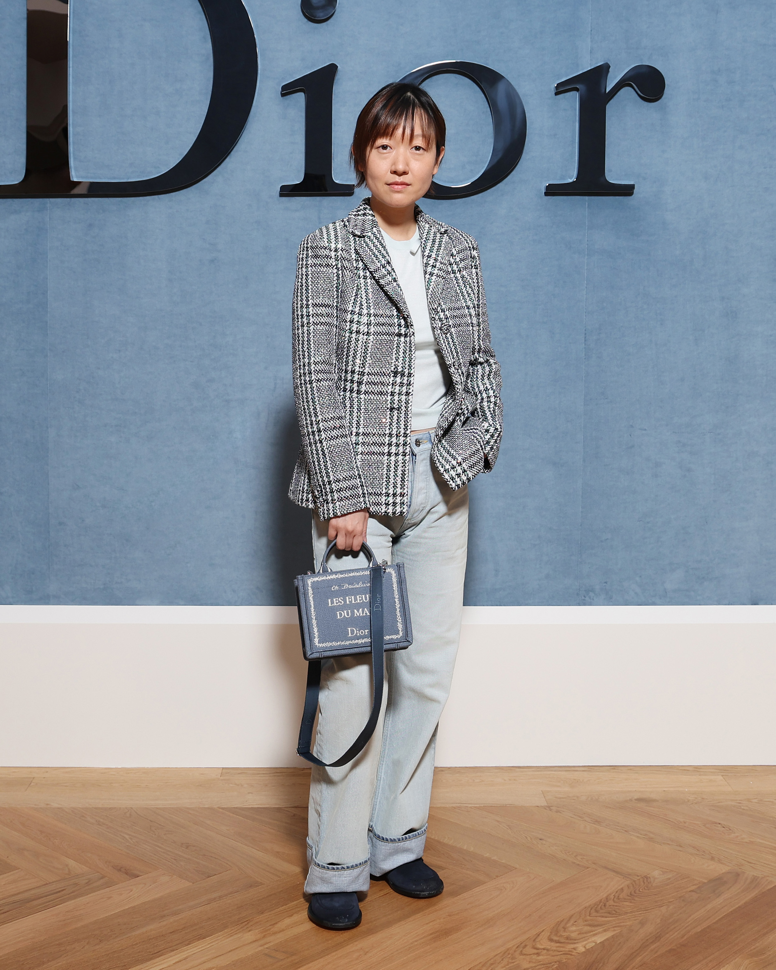 Celine Song at Dior ss26 menswear with book tote