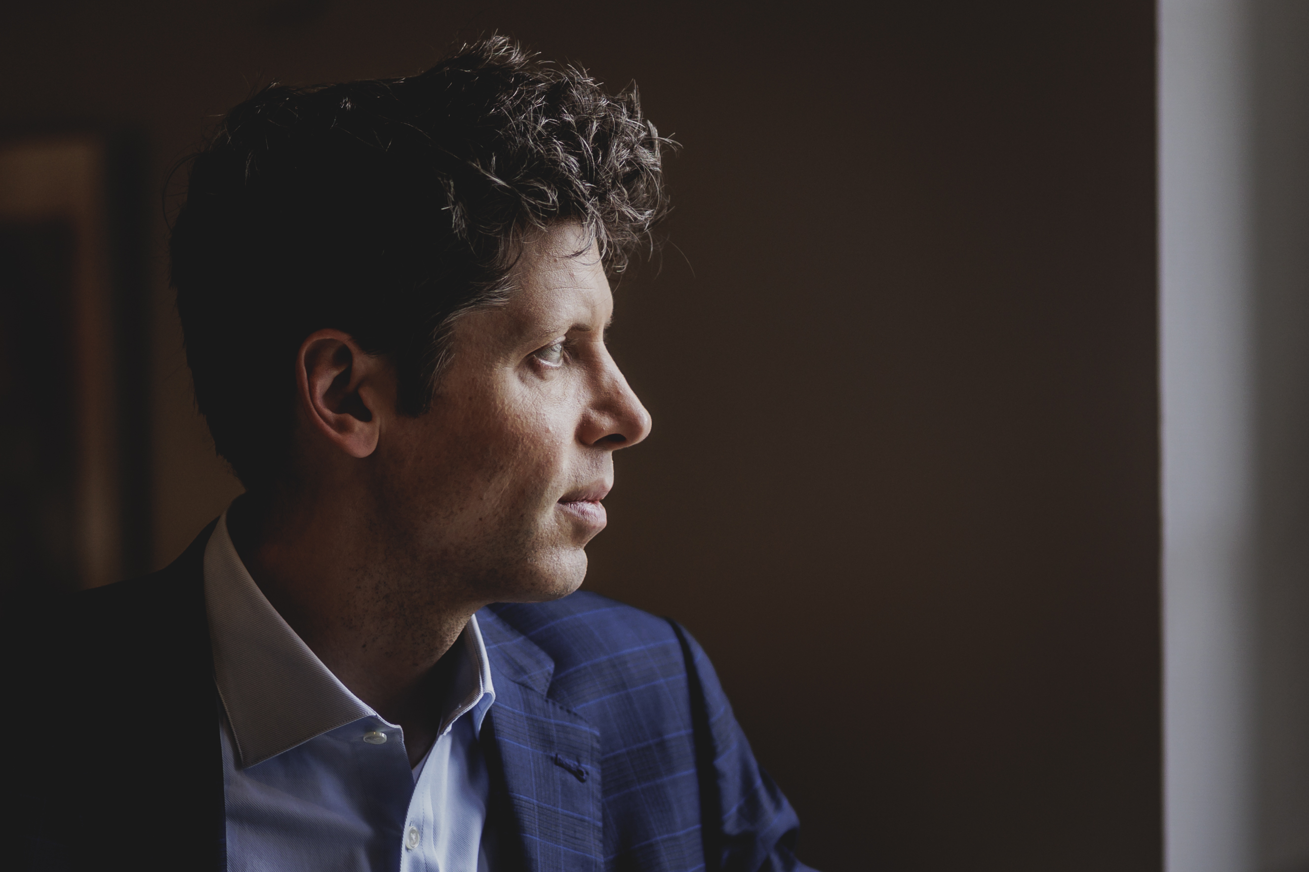 Sam Altman, CEO of OpenAI looking pensive off-camera