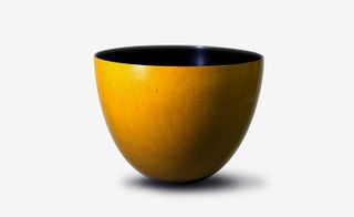 A yellow bowl with a black internal colour.