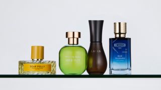 Green, blue, and brown perfume bottles in various shapes