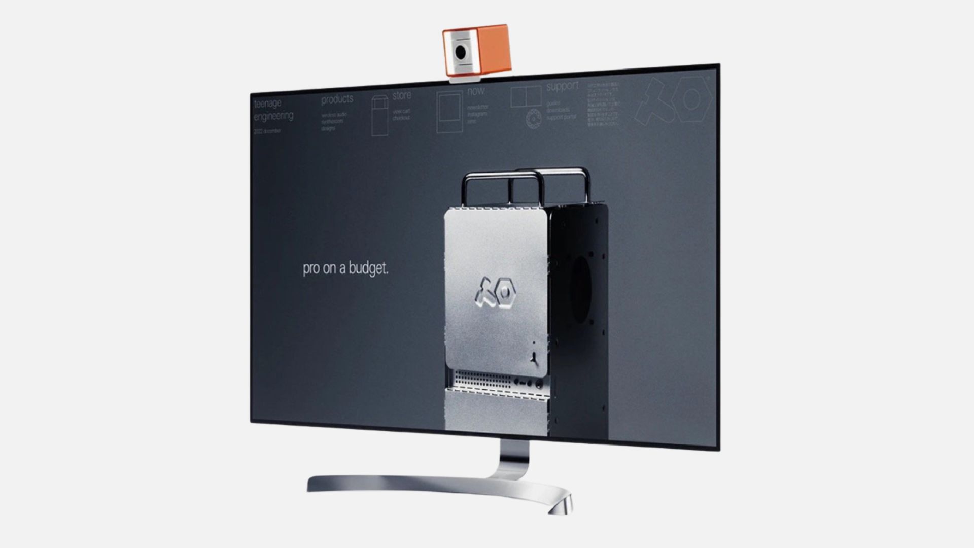 an image of the orange mini webcam clipped on top of a large monitor