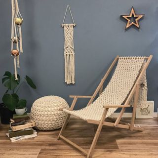 room with cream colour deck chair and macrame plant hanger on walls