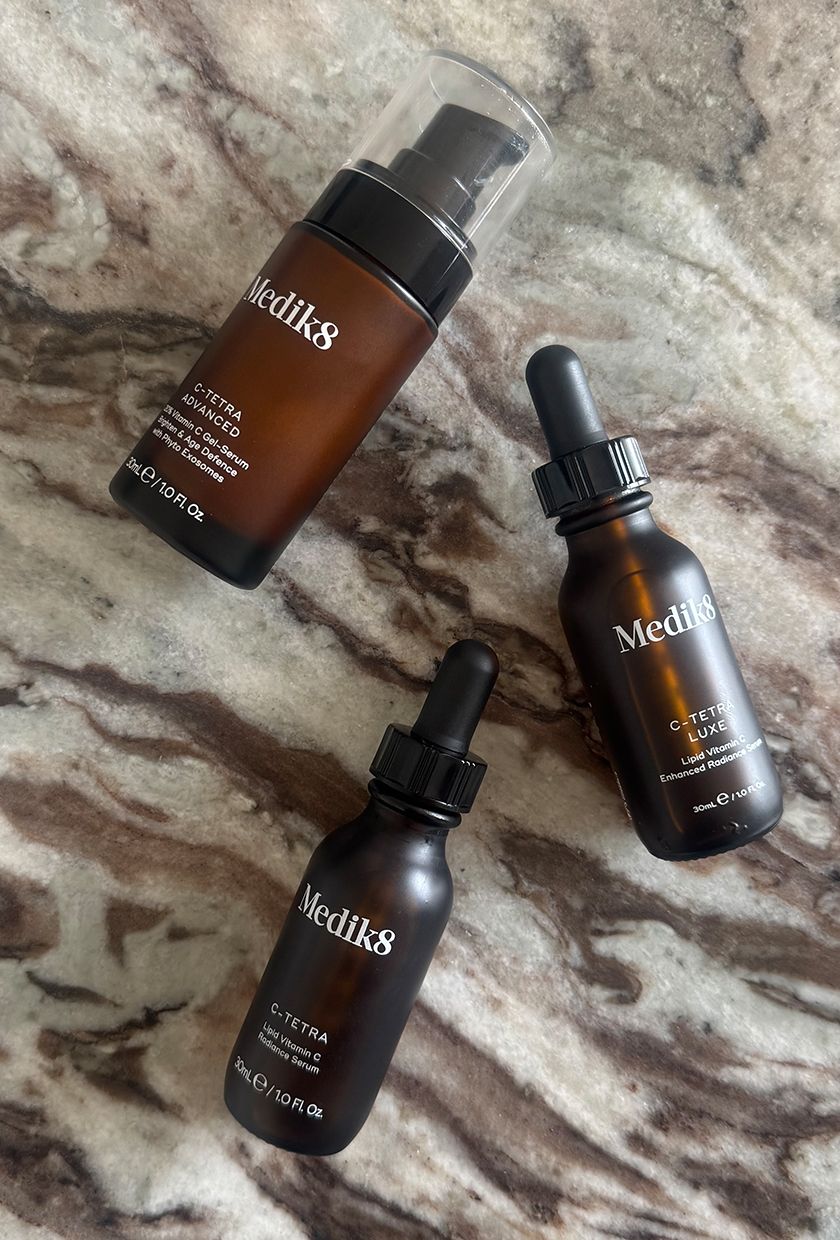 Medik8 C-Tetra serums close up on marble table, including Medik8 C-Tetra Advanced, C-Tetra Luxe and C-Tetra
