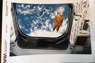 A NASA photograph shows Steve Denison's Barbie doll floating aboard the flight deck of the space shuttle Atlantis in November 1990. The photo has been signed and inscribed by four of the five members of the STS-38 crew, who adopted Barbie as their mission's "mascot."