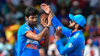 India&#039;s Washington Sundar (L) celebrates with Virat Kohli (R) after taking a wicket ahead of the 