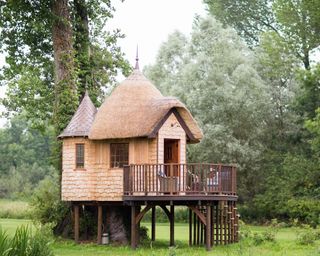 thatched roof treehouse with raised deck