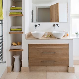 white walled bathroom with tiled flooring and drawers