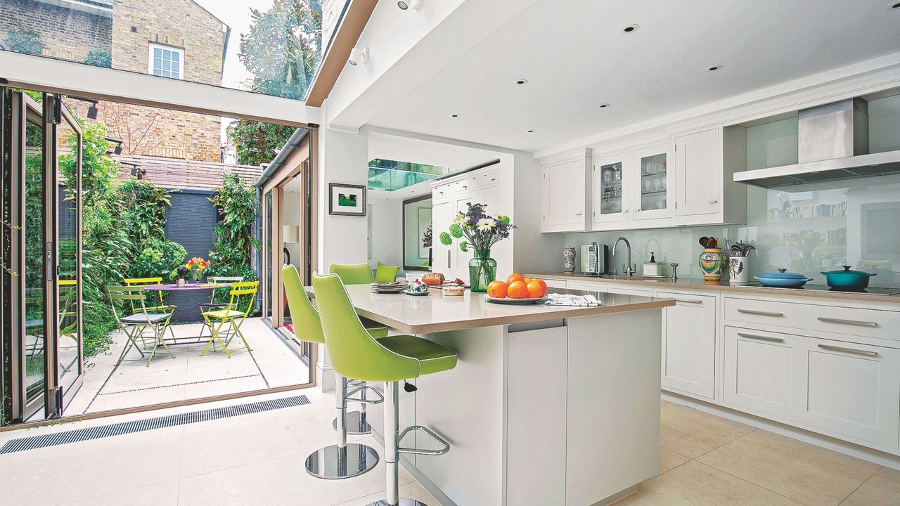 Modern kitchen extension with kitchen island, bifold doors to the garden and a glazed roof to flood the space with light