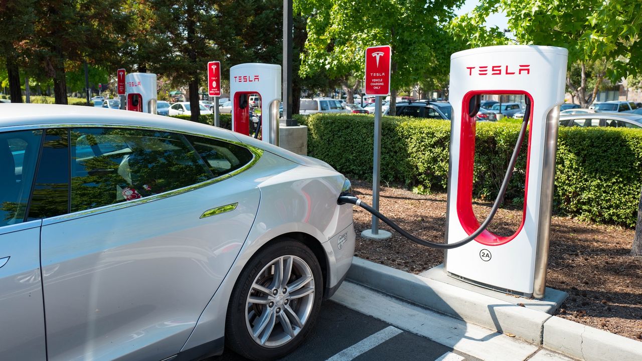A Tesla plugged into a supercharger station