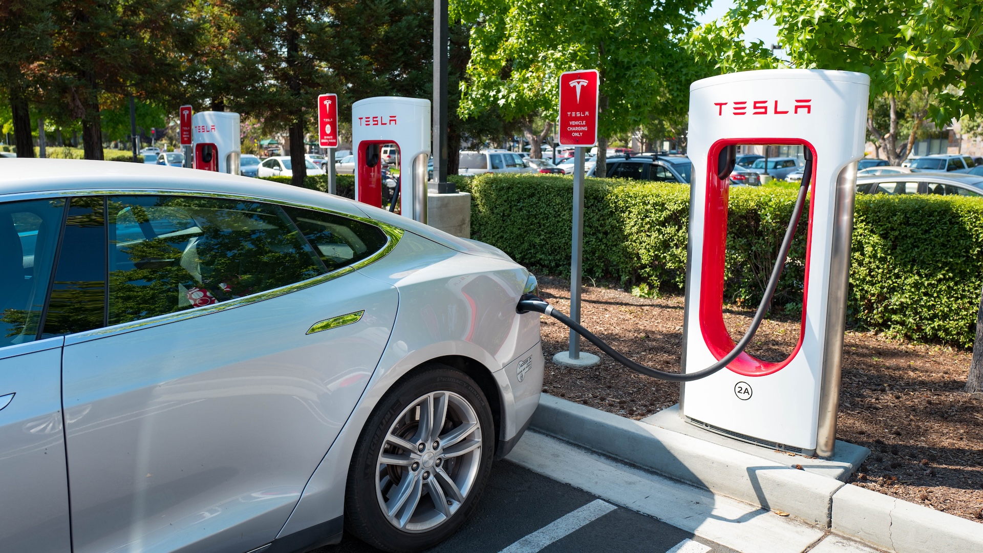 A Tesla plugged into a supercharger station