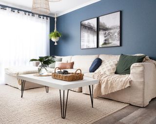 A modern living room with blue wall paint decor and white modern coffee table upcycle with black hairpin legs