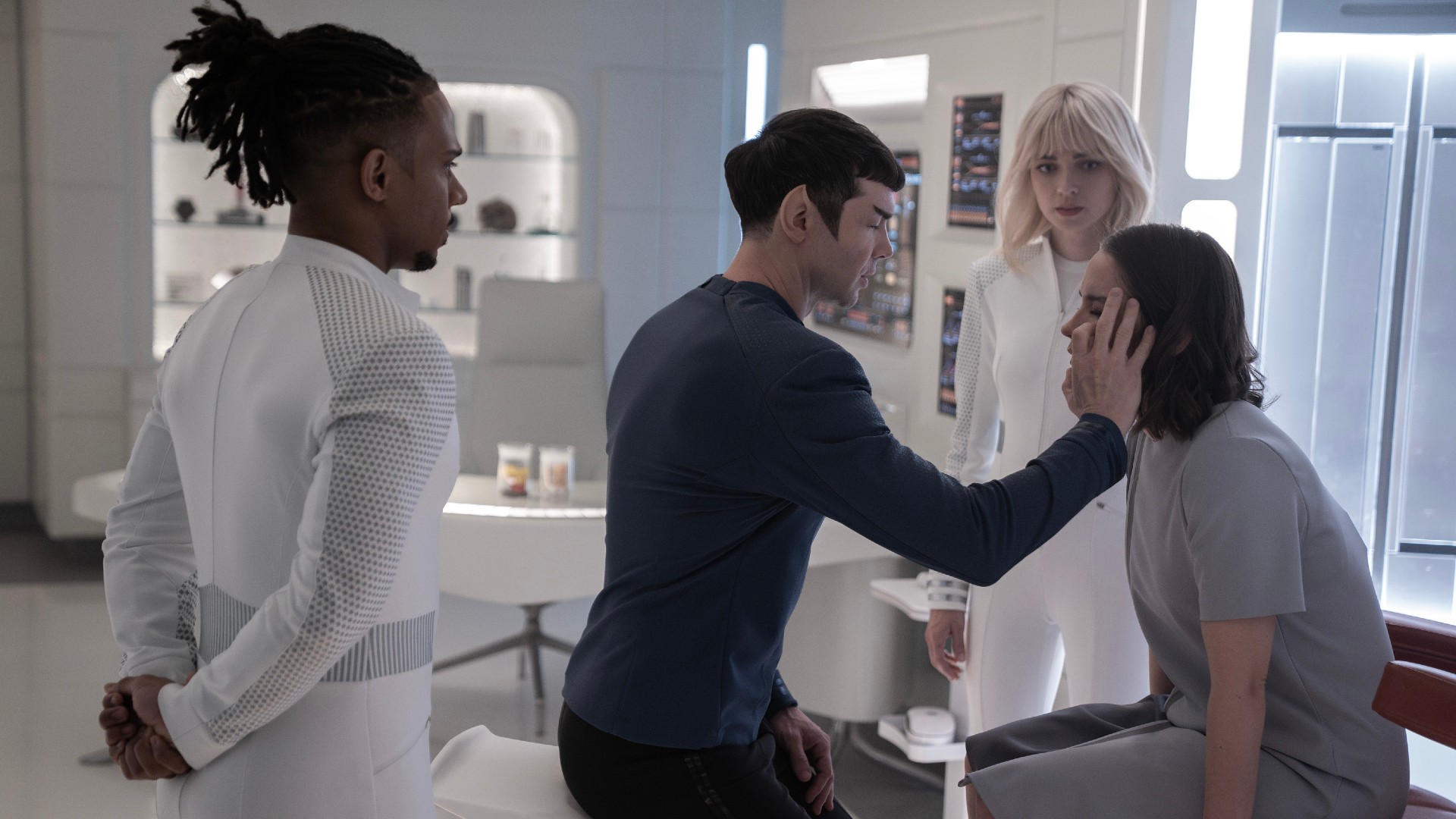 Spock is checking up on a patient. L to R Ethan Peck as Spock, Jess Bush as Chapel and Melanie Scrofano as Batel in season 3 , Episode 3 of Strange New Worlds streaming on Paramount+.