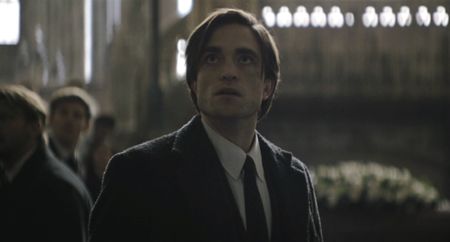 Bruce Wayne looking up at The Riddler in The Batman