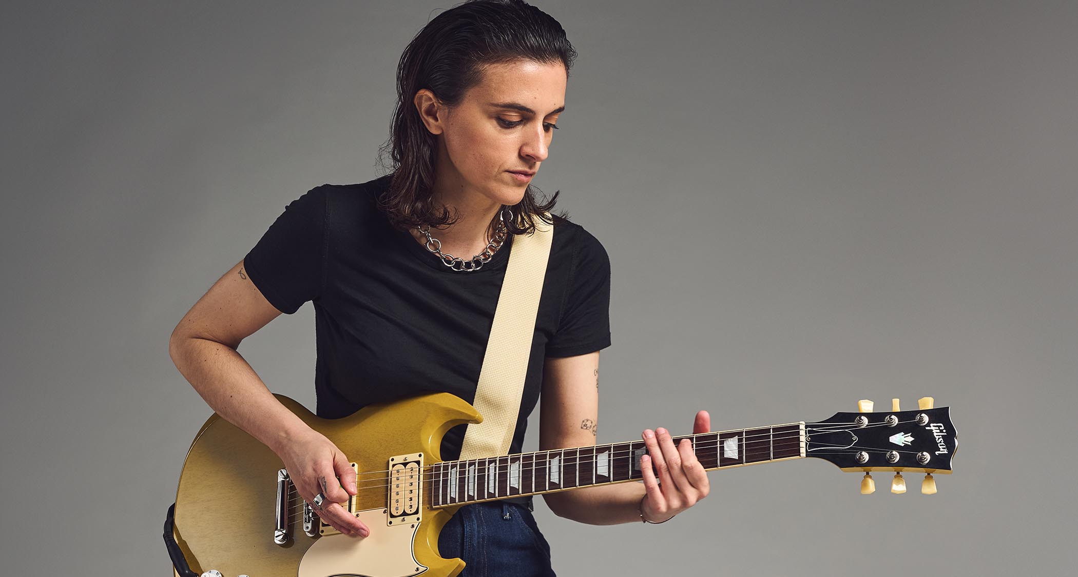Laura Cox photographed with her gold Gibson SG