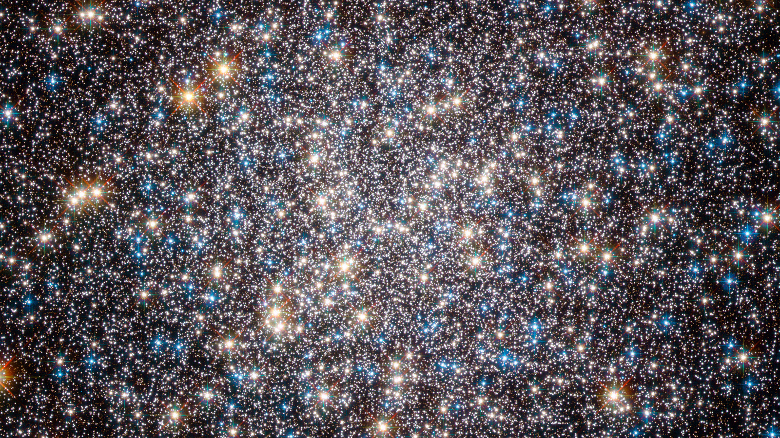 A starry image against a dark background full of blue and white and yellow stars.