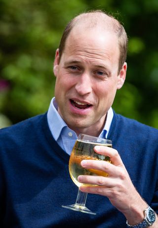 Prince William drinking at a pub