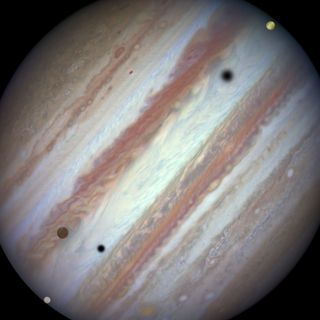 Three moons and their shadows move across Jupiter during a rare triple transit on Jan. 24, 2015. Europa is at lower left, Callisto is above and to the right of Europa and Io is approaching Jupiter's eastern limb. Europa's shadow is toward the left side of the image and Callisto's shadow to the right.