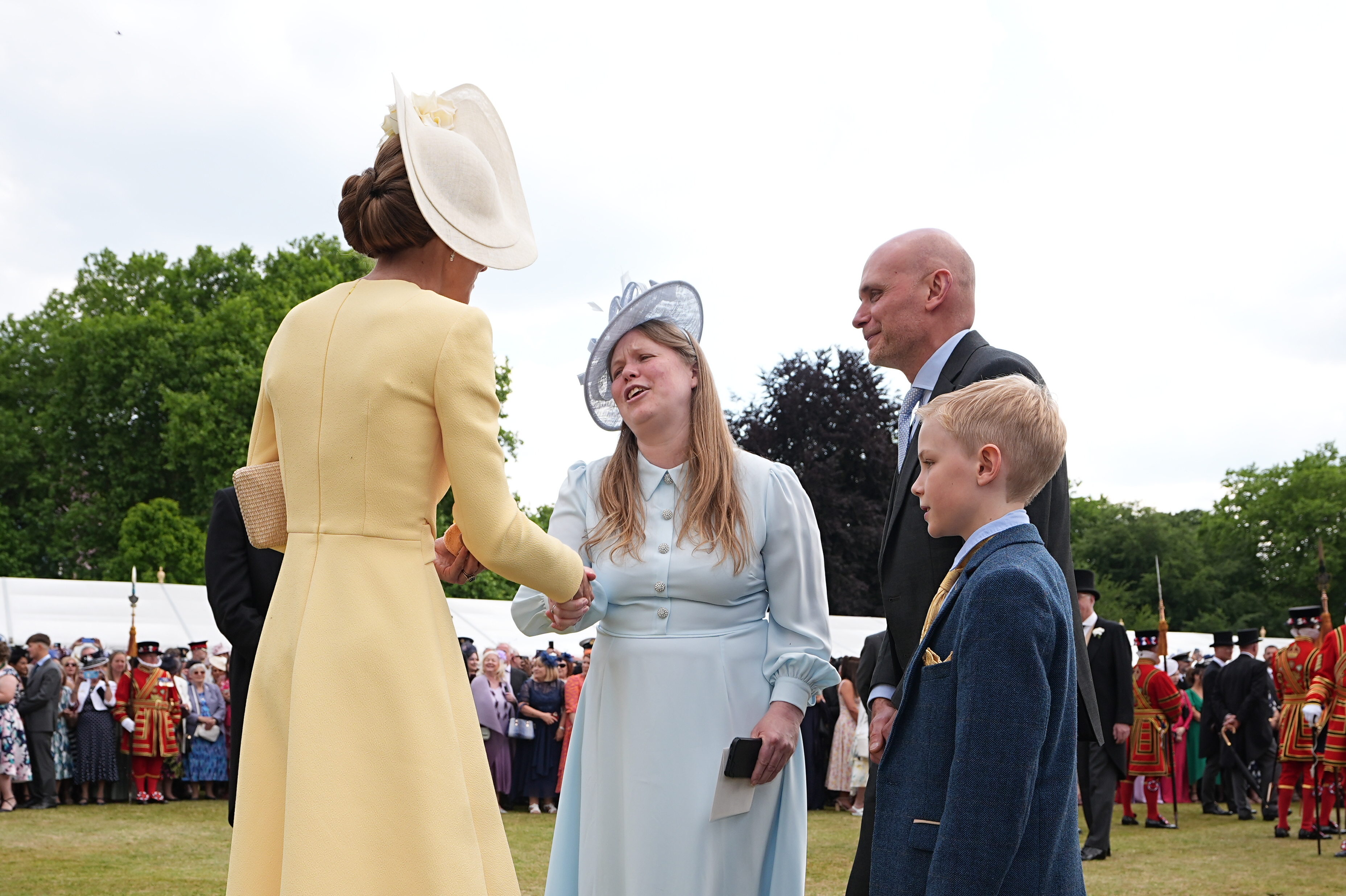 Kate Middleton shaking hands with Vicky Robayna at a garden party
