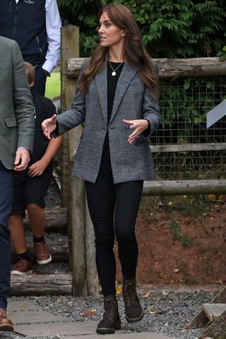 Kate Middleton wears a tweed blazer and black jeans as she talk to Sam Stables (L) during their visit to We Are Farming Minds charity at Kings Pitt Farm on September 14, 2023 in Hereford, England.