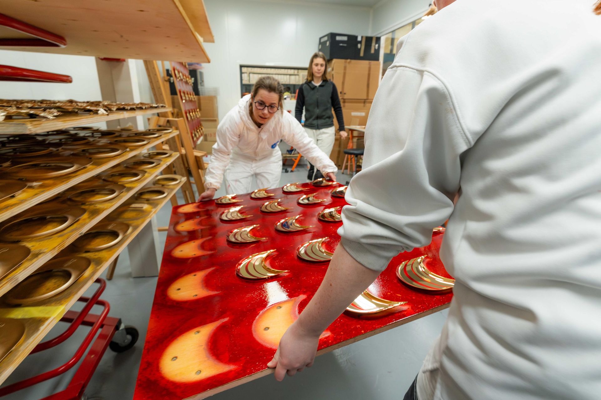 Artisans place lacquered and gilded speaker parts to dry